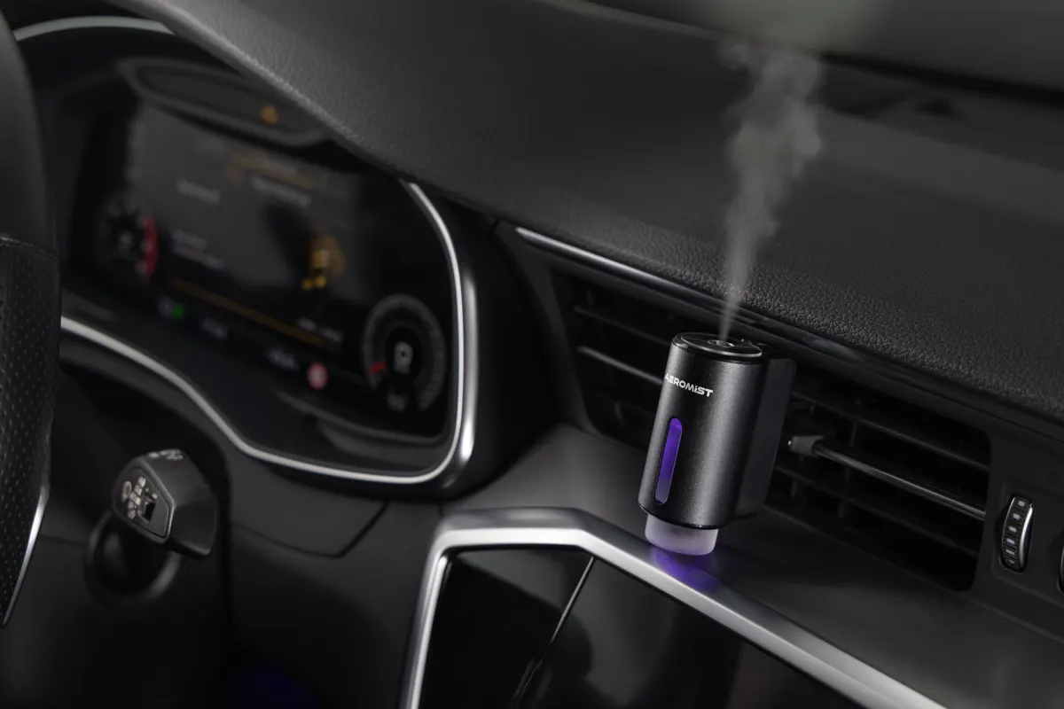 AeroMist misting from the air vent of a car dashboard